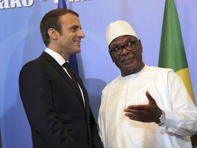 French President Emmanuel Macron speaks with Malian President Ibrahim Boubacar Keita during the opening session of G5 Shel force summit in Bamako, Mali, Sunday, July 2, 2017. Macron is meeting with heads of state from five nations across Africa's Sahel region to strengthen a new 5,000-strong regional force meant to counter a growing threat from extremists who have targeted tourist resorts and other high-profile areas. (AP Photo/Baba Ahmed)