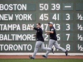 New York Yankees' Adam Warren (43) and Jonathan Holder (65) warm up before a baseball game against the Boston Red Sox in Boston, Friday, July 14, 2017. (AP Photo/Michael Dwyer)