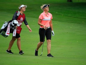 Brooke Henderson (right) walks the fairway with her sister and caddie, Brittany, at the Marathon Classic on July 20.