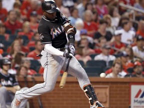 Miami Marlins' Marcell Ozuna hits an RBI double during the fourth inning of the team's baseball game against the St. Louis Cardinals on Wednesday, July 5, 2017, in St. Louis. (AP Photo/Jeff Roberson)