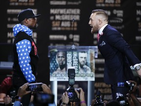Floyd Mayweather, left, and Conor McGregor face off at the first of four news conferences this week to promote their August fight in Las Vegas.
