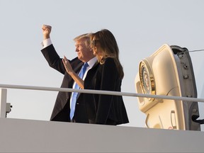 President Donald Trump and first lady Melania Trump board Air Force One, Wednesday, July 12, 2017, in Andrews Air Force Base, Md., en route to Paris. (AP Photo/Carolyn Kaster)