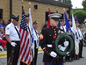 In this May 25, 2009, photo U.S. Marine Staff Sgt. William Kundrat places a wreath during a Memorial Day ceremony at the FSK Post 11, American Legion in Frederick, Md. Kundrat, 33, who grew up in Frederick, Md., was killed in a plane crash Monday, July 10, 2017, in Mississippi. (Sam Yu/The Frederick News-Post via AP)
