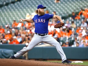 Texas Rangers starting pitcher Andrew Cashner winds up during the first inning of the team's baseball game against the Baltimore Orioles in Baltimore, Monday, July 17, 2017. (AP Photo/Patrick Semansky)