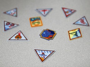 In this July 21, 2017 photo, a Girl Scout badge for learning how to program a robot is seen beneath a sample of new badges focused on science, technology, engineering and math in Owings Mills, Md. The new group of 23 badges takes a progressive approach to STEM and also nudges girls to become citizen scientists using the great outdoors as their laboratory. (AP Photo/Patrick Semansky)