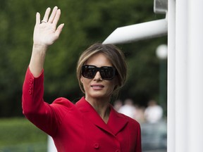 Melania Trump waves after a boat trip down the River Seine in Paris, Thursday, July 13, 2017.