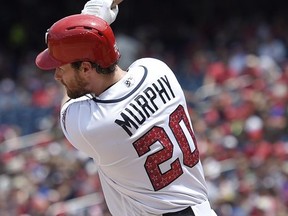 Washington Nationals' Daniel Murphy follows through on a single that scored two runs during the sixth inning of a baseball game against the New York Mets, Tuesday, July 4, 2017, in Washington. The Nationals won 11-4. (AP Photo/Nick Wass)