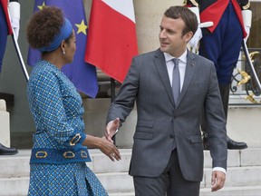 Secretary General of the International Organisation of La Francophonie (International Organisation of French-speaking countries) Michaelle Jean, left, and French President Emmanuel Macron shake hands after a meeting at the Elysee Palace in Paris, France, Monday, July 31, 2017. (AP Photo/Michel Euler)