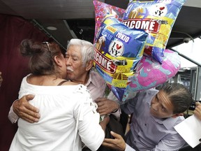 Luis Mendez Chanes, center, is reunited with his daughter Marta Mendez who he hasn't seen in 24-years, and her husband Luis Flores, from Queens, as they ride the Bateaux New York boat, Wednesday, July 5, 2017 in New York. The reunification was possible because of an agreement between the Mexican state of Morelos and the U.S. government, which granted tourist visas to the Mexican visitors. (AP Photo/Richard Drew)