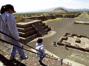 Tourists walk down the Pyramid of the Moon in the ancient city of Teotihuacan, Mexico.