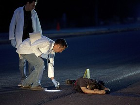 In this early Thursday, June 29, 2017 photo, investigators mark the spot where spent bullet casings fell next to a body lying on a road in the town of Navolato, Sinaloa state, Mexico. 59 AK type and AR-15 casings were found in the area. Early Saturday July 1st, Mexican authorities said that at least 19 people died in clashes between armed men and security forces in the town of Villa Union, about 15 miles (24 kilometers) southeast of the beach resort of Mazatlan, in the gang-plagued northwestern state of Sinaloa, where violence has spiked dramatically following the capture and extradition of convicted drug lord Joaquin "El Chapo" Guzman.(AP Photo/Enric Marti)