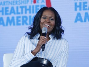 In this Friday, May 12, 2017, file photo, former first lady Michelle Obama smiles while speaking at the Partnership for a Healthier American 2017 Healthier Future Summit in Washington.