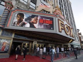 Movie goers arrive at the Fox Theatre for the premiere of "Detroit," Tuesday, July 25, 2017, in Detroit. The movie, directed by Kathryn Bigelow is set in the summer of 1967 where rioting and civil unrest tore apart the city of Detroit. (AP Photo/Carlos Osorio)