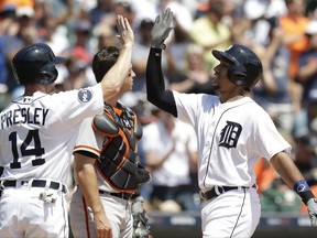 Detroit Tigers' Dixon Machado, right, is congratulated by Alex Presley after they both scored on Machado's two-run home run during the second inning of a baseball game against the San Francisco Giants, Thursday, July 6, 2017, in Detroit. (AP Photo/Carlos Osorio)