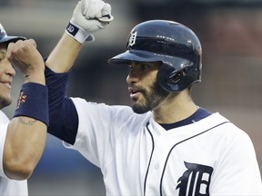 Detroit Tigers' J.D. Martinez, right, is congratulated by Miguel Cabrera after they and Justin Upton scored on Martinez's three-run home run during the eighth inning against the Toronto Blue Jays in a baseball game Saturday, July 15, 2017, in Detroit. (AP Photo/Carlos Osorio)