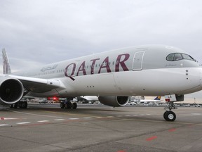 FILE - In this Jan. 15, 2015, file photo, a new Qatar Airways Airbus A350 approaches the gate at the airport in Frankfurt, Germany. Qatar Airways joined two other major long-haul Gulf carriers on Thursday, July 6, 2017 in getting off a U.S. ban on laptops and large electronics in airplane cabins, despite facing logistical challenges amid the country's diplomatic dispute with several Arab nations. (AP Photo/Michael Probst, File)