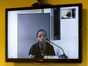 Lovily Kristine-Anwonette Johnson  appears on a video monitor for her arraignment at Wyoming District Court on Monday, July 24, 2017 in Wyoming, Mich. Court records say Johnson was charged with first-degree murder and first-degree child abuse in the death of 6-month-old Noah Johnson.  (Cory Morse/The Grand Rapids Press via AP)