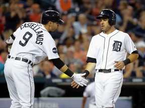 Detroit Tigers' Ian Kinsler, right, celebrates after scoring with Nicholas Castellanos (9) on a Miguel Cabrera (24) single against the Kansas City Royals in the sixth inning of a baseball game in Detroit, Monday, July 24, 2017. (AP Photo/Paul Sancya)
