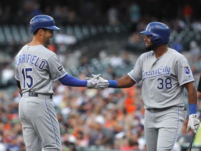 Kansas City Royals' Whit Merrifield (15) celebrates his lead off solo home run with Jorge Bonifacio (38) against the Detroit Tigers in the first inning of a baseball game in Detroit, Tuesday, July 25, 2017. (AP Photo/Paul Sancya)