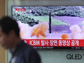 A man walks by a TV screen showing a local news program reporting about North Korea's missile firing at Seoul Train Station in Seoul, South Korea, Wednesday, July 5, 2017. North Korea's newly demonstrated missile muscle puts Alaska within range of potential attack and stresses the Pentagon's missile defenses like never before. Even more worrisome, it may be only a matter of time before North Korea mates an even longer-range ICBM with a nuclear warhead, putting all of the U.S. at risk.  (AP Photo/Lee Jin-man)