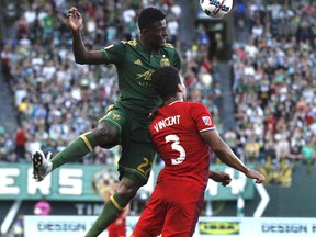 Portland Timbers' Darien Asprilla (27) heads a ball next to Chicago Fire's Brandon Vincent during an MLS soccer match Wednesday, July 5, 2017, in Portland, Ore. (Sean Meagher/The Oregonian via AP)
