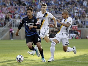 San Jose Earthquakes forward Chris Wondolowski (8) is chased by Los Angeles Galaxy defenders Dave Romney (4) and Rafael Garcia (25) during the first half of an MLS soccer match Saturday, July 1, 2017, in San Jose, Calif. (AP Photo/Marcio Jose Sanchez)