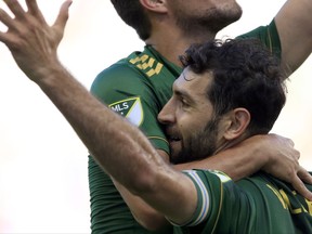 Portland Timbers midfielder Diego Valeri celebrates his goal with teammates during the first half of an MLS soccer match against Sporting Kansas City in Kansas City, Kan., Saturday, July 1, 2017. (AP Photo/Orlin Wagner)
