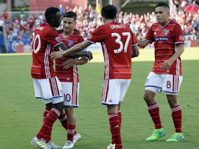 FC Dallas' Roland Lamah, left, celebrates his second goal of the game with Mauro Diaz (10), Maximiliano Urruti (37) and Victor Ulloa (8) during the first half of an MLS soccer match against Toronto FC on Saturday, July 1, 2017, in Frisco, Texas. (AP Photo/Tony Gutierrez)