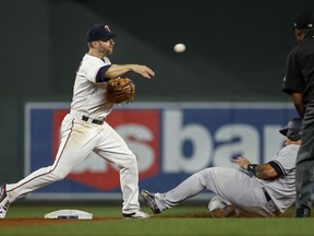 Minnesota Twins second baseman Brian Dozier throws to first after forcing out New York Yankees' Gary Sanchez during the ninth inning of a baseball game Tuesday, July 18, 2017, in Minneapolis. Aaron Judge was out at first. The Yankees won 6-3. (AP Photo/Bruce Kluckhohn)