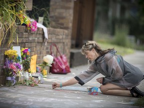 Megan O'Leary, of St. Paul, leaves a message on Monday, July 17, 2017,  near the scene where a Minneapolis police officer shot and killed Justine Damond, of Australia,  in Minneapolis.