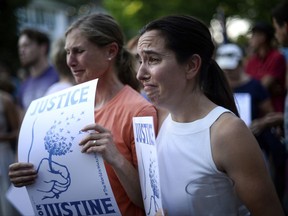 Betsy Custis, right, and others attend a march in honor of Justine Damond at Beard's Plaissance Park, Thursday, July 20, 2017, in Minneapolis.