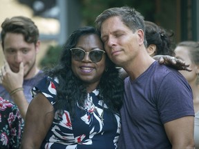 Don Damond, the fiance of Justine Damond, is comforted outside his home by Valerie Castile, the mother of Philando Castile, as demonstrators march by Damond's home during a march in honor of Justine Damond, Thursday, July 20, 2017, in Minneapolis.
