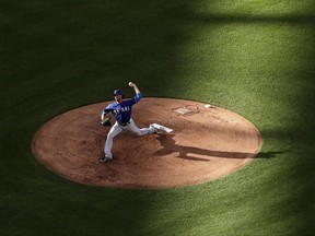 Texas Rangers starting pitcher Cole Hamels throws during the first inning of the team's baseball game against the Kansas City Royals on Saturday, July 15, 2017, in Kansas City, Mo. (AP Photo/Charlie Riedel)