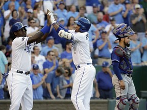 Kansas City Royals' Alcides Escobar, right, celebrates with Jorge Soler after hitting a two-run home run during the second inning of a baseball game against the Texas Rangers Friday, July 14, 2017, in Kansas City, Mo. (AP Photo/Charlie Riedel)
