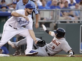 Detroit Tigers' Nicholas Castellanos (9) beats the tag at third by Kansas City Royals third baseman Mike Moustakas after hitting a two-run triple during the second inning of a baseball game Tuesday, July 18, 2017, in Kansas City, Mo. (AP Photo/Charlie Riedel)