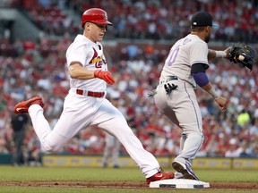 St. Louis Cardinals' Harrison Bader arrives at first on a ground-out in his first major league at-bat as Colorado Rockies first baseman Ian Desmond handles the throw during the second inning of a baseball game Tuesday, July 25, 2017, in St. Louis. (AP Photo/Jeff Roberson)