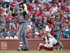 Arizona Diamondbacks' J.D. Martinez (28) looks skyward after scoring past St. Louis Cardinals catcher Yadier Molina on a solo home run during the fourth inning of a baseball game Saturday, July 29, 2017, in St. Louis. (AP Photo/Jeff Roberson)