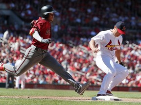 Arizona Diamondbacks' Ketel Marte, left, is out as St. Louis Cardinals relief pitcher Seung-Hwan Oh beats Marte to first during the eighth inning of a baseball game, Sunday, July 30, 2017, in St. Louis. The Cardinals won 3-2. (AP Photo/Jeff Roberson)