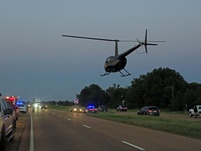 Emergency officials respond to the site of a military plane crash near Itta Bena, Miss., Monday, July 10, 2017. Leflore County Emergency Management Agency Director Frank Randle told reporters at a late briefing that more than a dozen bodies had been recovered after the KC-130 spiraled into the ground about 85 miles (135 kilometers) north of Jackson in the Mississippi Delta. (Elijah Baylis/The Clarion-Ledger via AP)