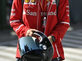 German F1 driver Sebastian Vettel of Ferrari, walks through the paddock prior to the third free practice session on the Hungaroring circuit in Mogyorod, 23 kms north-east of Budapest, Hungary, Saturday, July 29, 2017. The Hungarian Formula One Grand Prix will be held on Sunday July, 30. (Zsolt Czegledi/MTI via AP)
