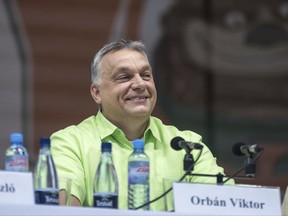 Hungarian Prime Minister Viktor Orban smiles as he is introduced before delivering a speach at the 28th Balvanyos Summer University and Students' Camp in Baile Tusnad, Transylvania, Romania, Saturday, July 22, 2017. (Nandor Veres/MTI via AP)