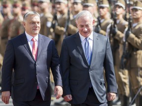 Staying on a four-day official visit in Hungary, Israeli Prime Minister Benjamin Netanyahu, right, and his Hungarian counterpart Viktor Orban inspect the honour guards during the reception ceremony in front of the Parliament building in Budapest, Hungary, Tuesday, July 18, 2017. (Balazs Mohai/MTI via AP)