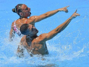 Winners Manila Flamini and Giorgio Misini of Italy perform in the synchronized swimming technical mixed duet final competition at the Swimming World Championships in the City Park, in Budapest, Hungary, Monday, July 17, 2017. (Zsolt Czegledi/MTI via AP)
