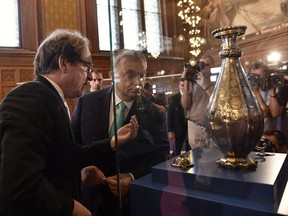 Hungarian Prime Minister Viktor Orban, right, and Director General of the Museum of Fine Arts of Budapest Laszlo Baan observe the exhibited Seuso-treasures in Budapest, Hungary, Wednesday, July 12, 2017.