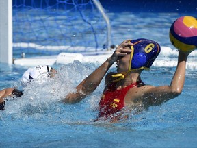 US Rachel Fattal, left, and Helena Lloret Gomez of Spain  compete during their women's water polo Group B second round match USA vs Spain of the Swimming World Championships in Hajos Alfred National Swimming Pool in Budapest, Hungary, Tuesday, July 18, 2017. (Balazs Czagany/MTI via AP)