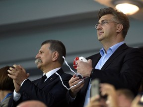 Croatian Prime Minister, Andrej Plenkovic, stands next to Speaker of the Hungarian Parliament, Laszlo Kover, left, before the start of the men's water polo final match Hungary vs Croatia at the 17th FINA Swimming World Championships in Hajos Alfred National Swimming Pool in Budapest, Hungary, Saturday, July 29, 2017. (Balazs Czagany/MTI via AP)