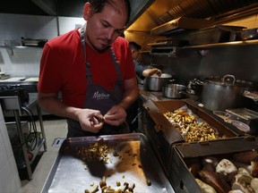 In this July 13, 2017 photo, chef Eduardo Garcia, founder of Maximo Bistrot and former migrant worker in the US, cuts mushrooms at his restaurant in Mexico City. People sometimes think (farm-to-table) is a trend," said Garcia. "It's not a trend. It's something that we humans have always done and we need to keep doing it, we need to return to it."(AP Photo/Marco Ugarte)