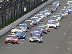 Kyle Busch, left, and Kevin Harvick (4) lead the field on the start of the NASCAR Brickyard 400 auto race at Indianapolis Motor Speedway in Indianapolis, Sunday, July 23, 2017. (AP Photo/Michael Conroy)