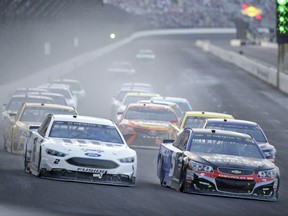 Kasey Kahne (5), right, takes the lead on the final restart as he heads into the first turn with Brad Keselowski (2) on his way to winning the NASCAR Brickyard 400 auto race at Indianapolis Motor Speedway, in Indianapolis Sunday, July 23, 2017. (AP Photo/AJ Mast)