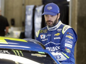 Race driver driver Jimmie Johnson climbs into his car before a practice session for the NASCAR auto race at Indianapolis Motor Speedway, in Indianapolis Saturday, July 22, 2017. (AP Photo/Darron Cummings)